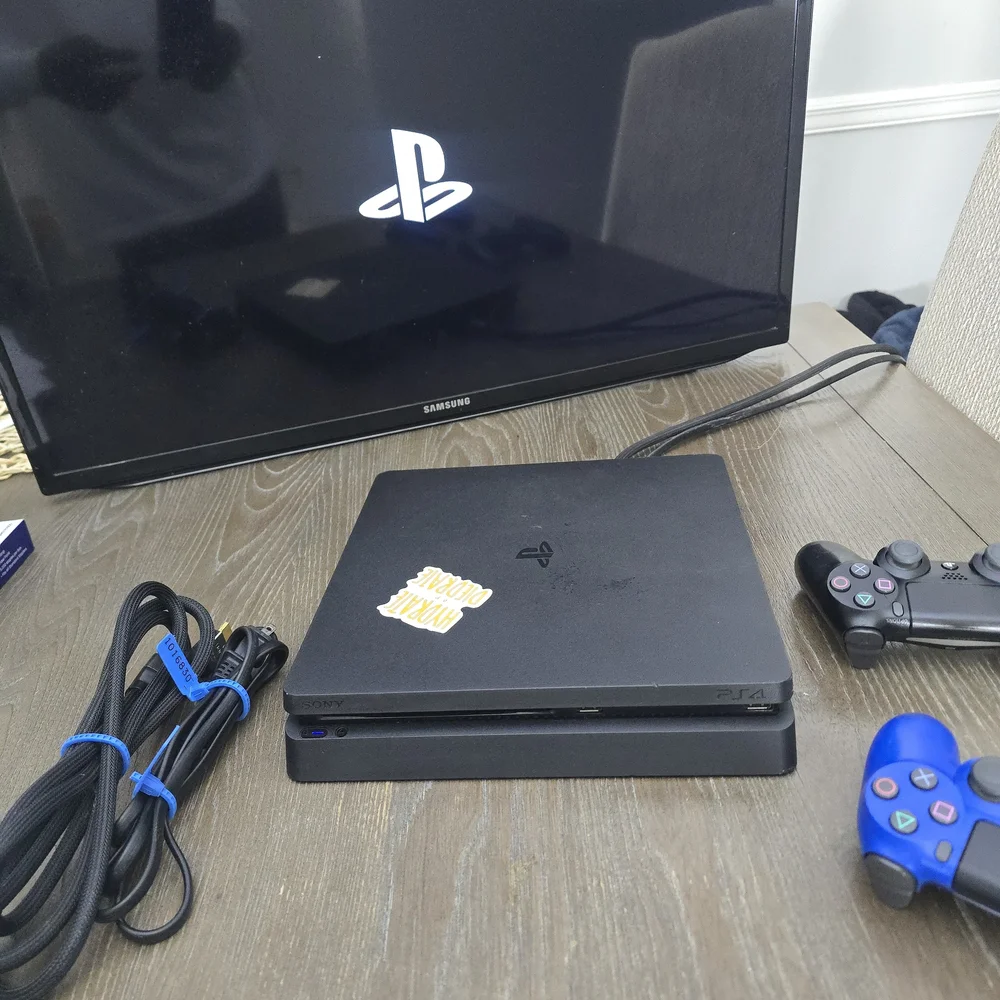 Sony PlayStation 4 Console with Black and Blue Controllers